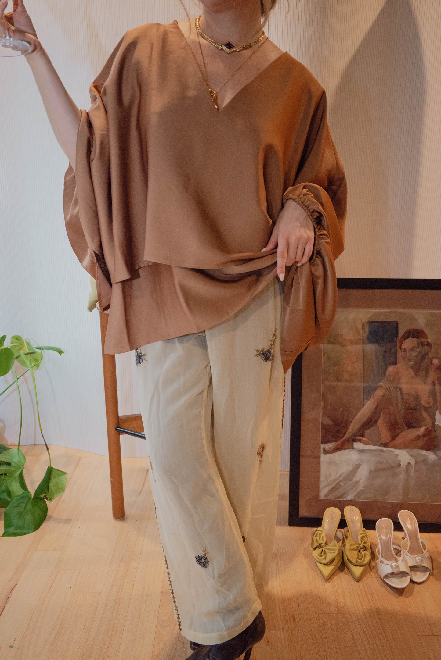 Chicago boutique owner wears a vintage Calvin Klein blouse with timeless draping for a chic holiday outfit.