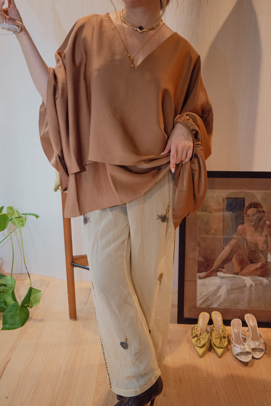 Chicago boutique owner wears a vintage Calvin Klein blouse with timeless draping for a chic holiday outfit.