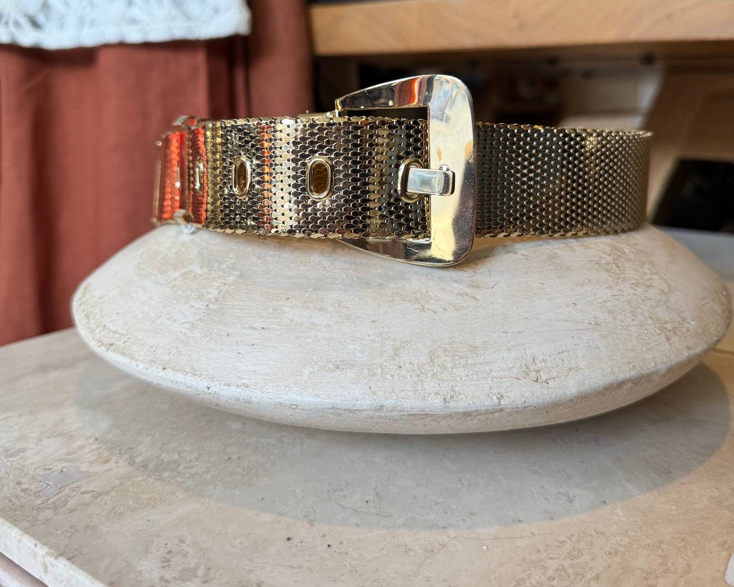 Vintage Whiting and Davis metallic belt sits on table for product shot for vintage store, Petals and Jackets in West Town, Chicago.