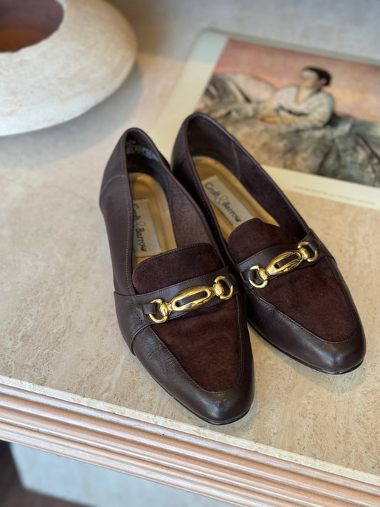 Vintage Croft and borrow shoes sit on a marble table for product shot in vintage boutique in Chicago.