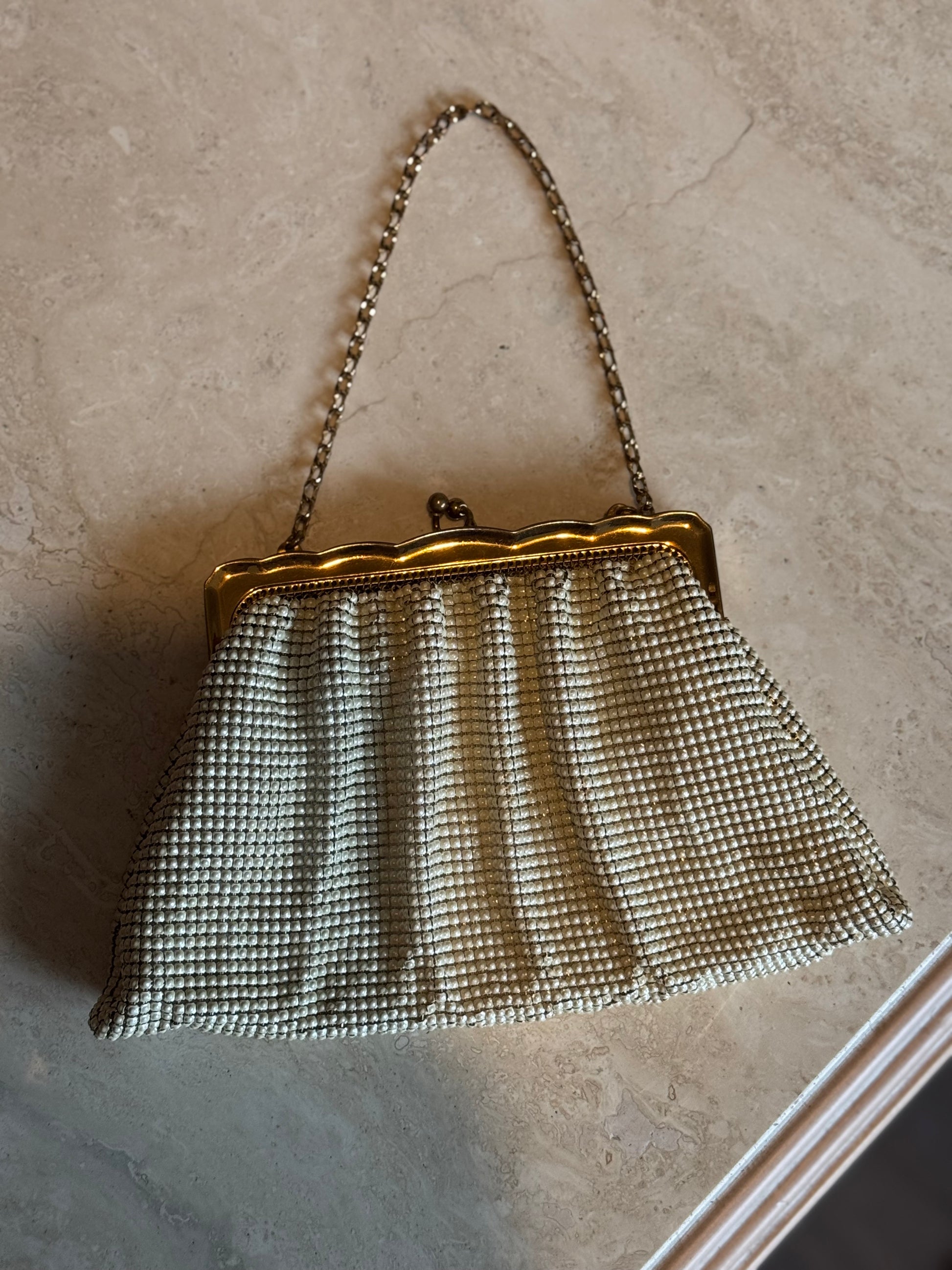 Chicago Vintage Store Petals and Jackets curated collection including vintage whiting and Davis change purse with ornate gold detailing.