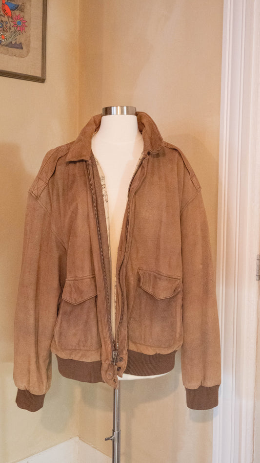 Vintage brown jacket with map lining on back of mannequin pictured in the corner of Petals and Jackets Boutique.