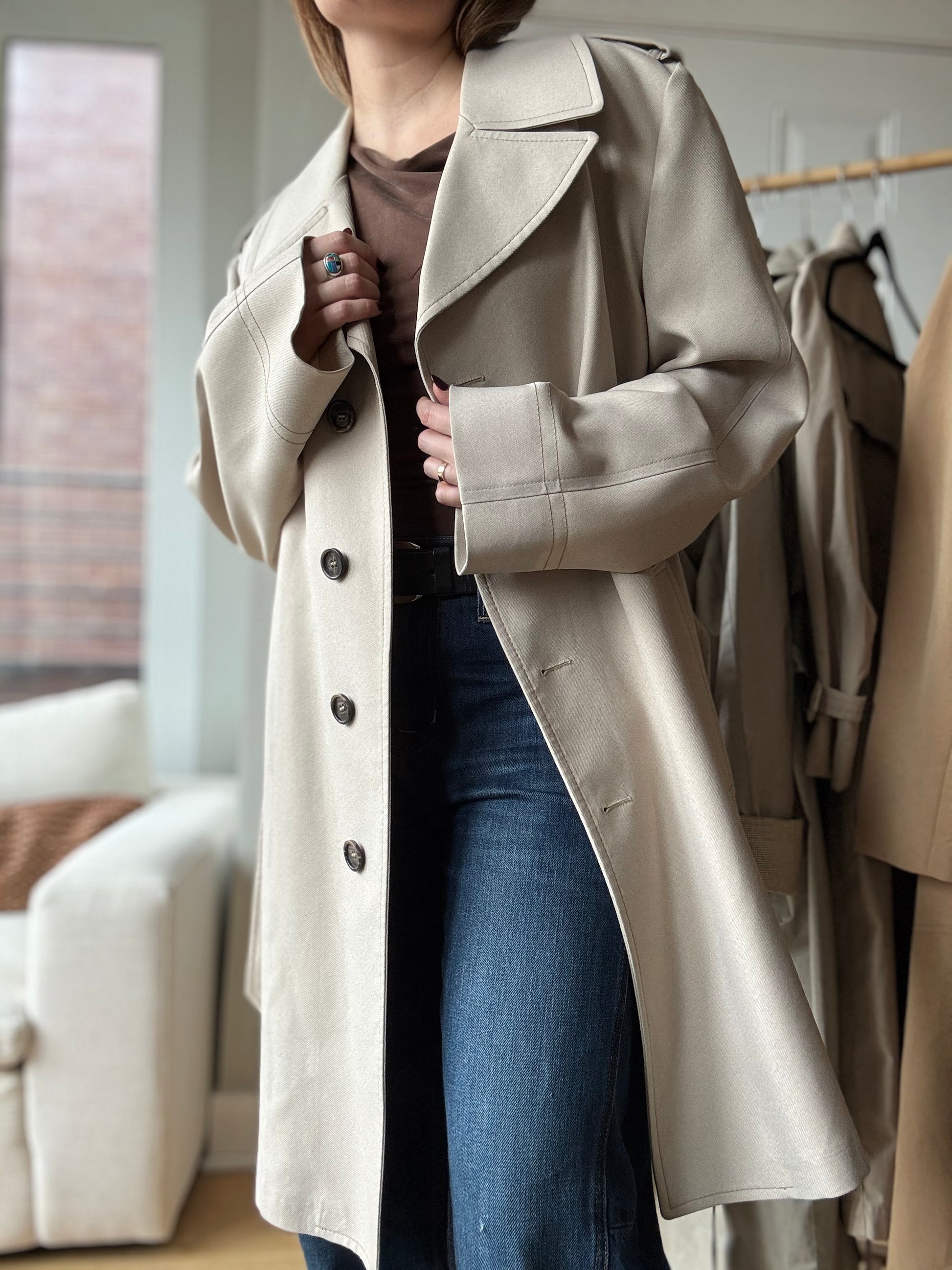 Woman wears a vintage trench coat from London Fog for a chic look over wide legged jeans in Chicago.