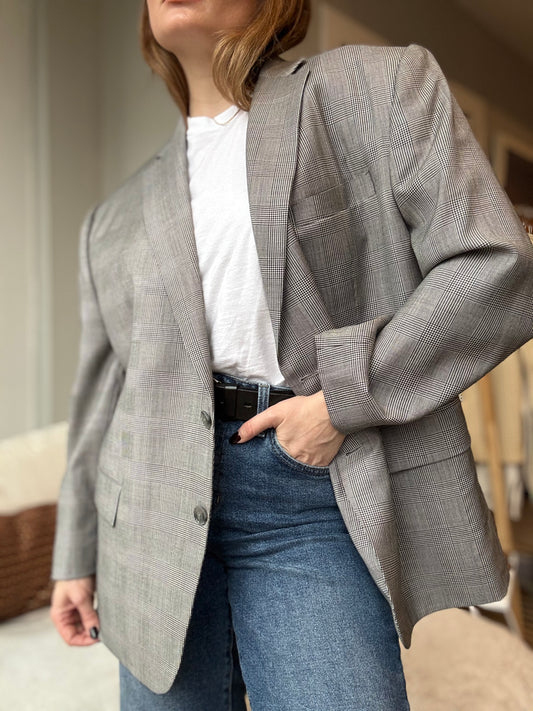 Woman wears oversized vintage Duru's Chicago tailored jacket over jeans for an edgy masculine look.