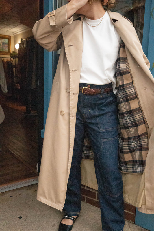 Woman poses in London Fog Trench Coat with plaid lining in front of Petals and Jackets boutique in Chicago, Illinois.