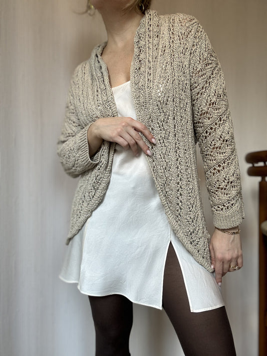 Chicago Small business owner wears a crocheted Vintage cardigan over a white slip dress for a fun holiday look.