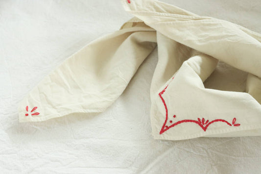Hand-dyed embroidered rodeo cotton bandana in sandy white/red thread
