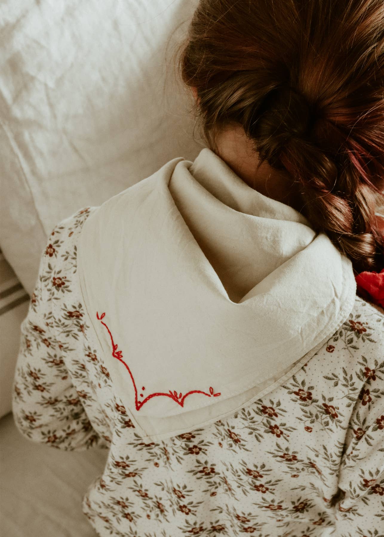 Hand-dyed embroidered rodeo cotton bandana in sandy white/red thread