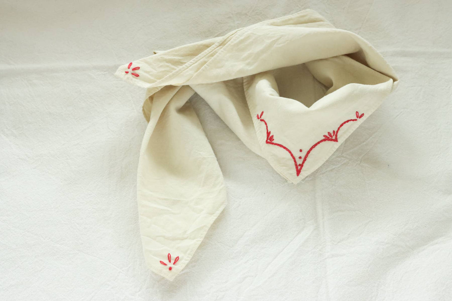 Hand-dyed embroidered rodeo cotton bandana in sandy white/red thread