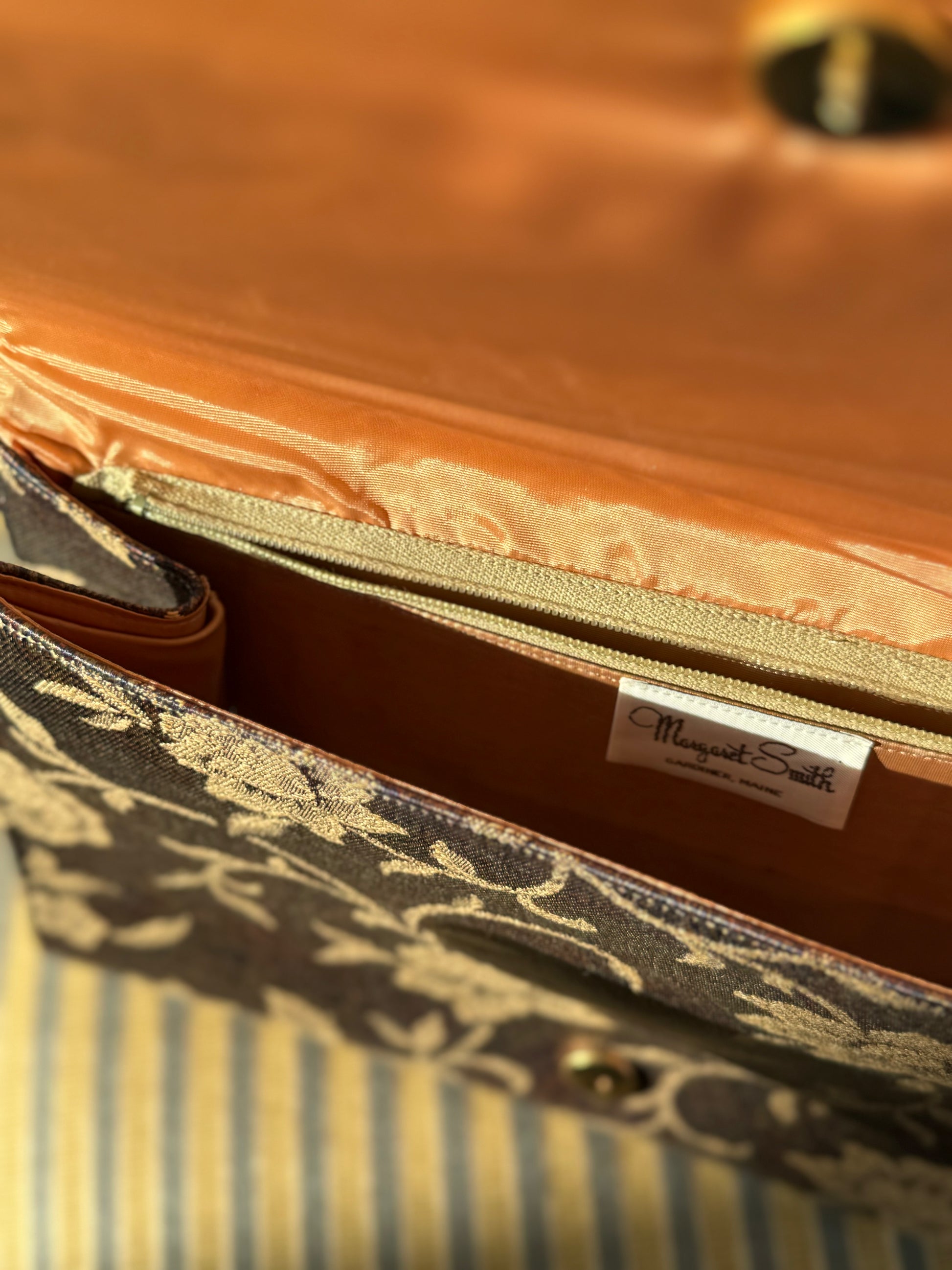 Margaret Smith Vintage purse sits on a vintage chair in Chicago Vintage boutique Petals & Jackets. 