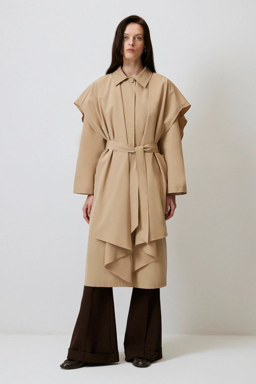 Woman layers structured trench jacket over flared black pants for a Chic spring outfit from local Chicago Boutique, Petals and Jackets. 