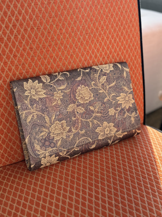 Vintage 1960s Margaret Smith tapestry handbag sits on a patterned chair in West Town Chicago boutique Petals and Jackets. 