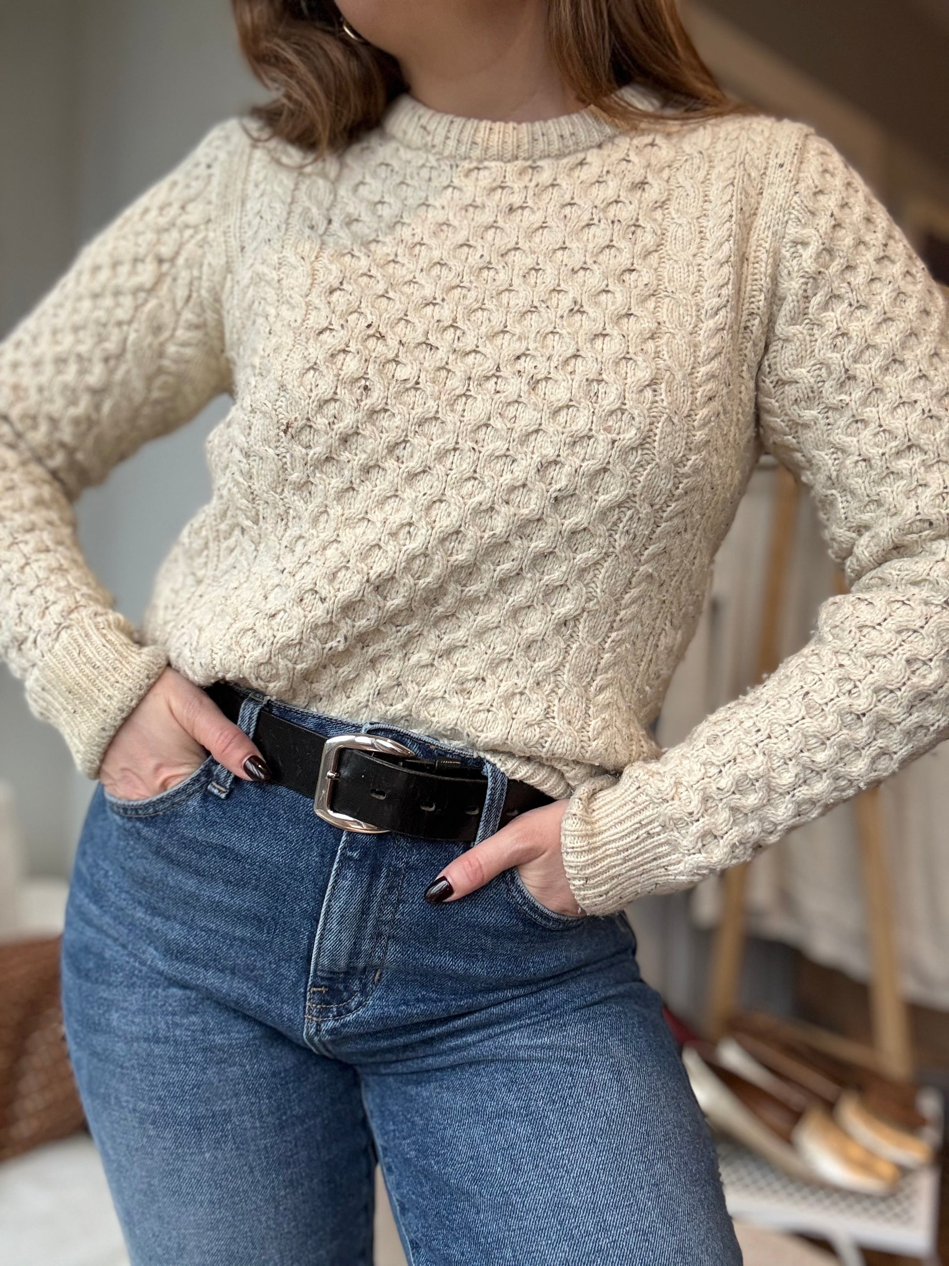 Chicago vintage owner styles cozy wool sweater with straight jeans and a black belt for a chic vintage look. 