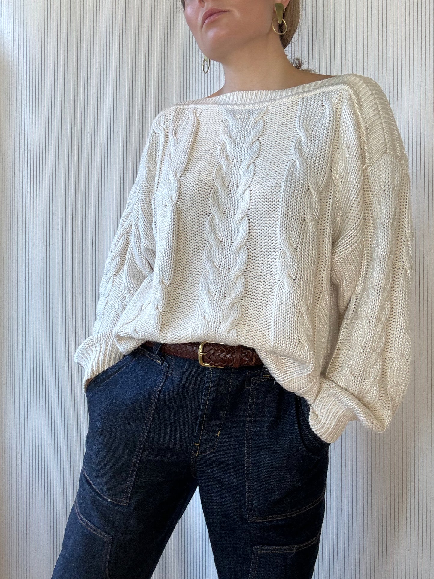 Woman wears a cable knit white vintage sweater from vintage boutique in West Town, Chicago 