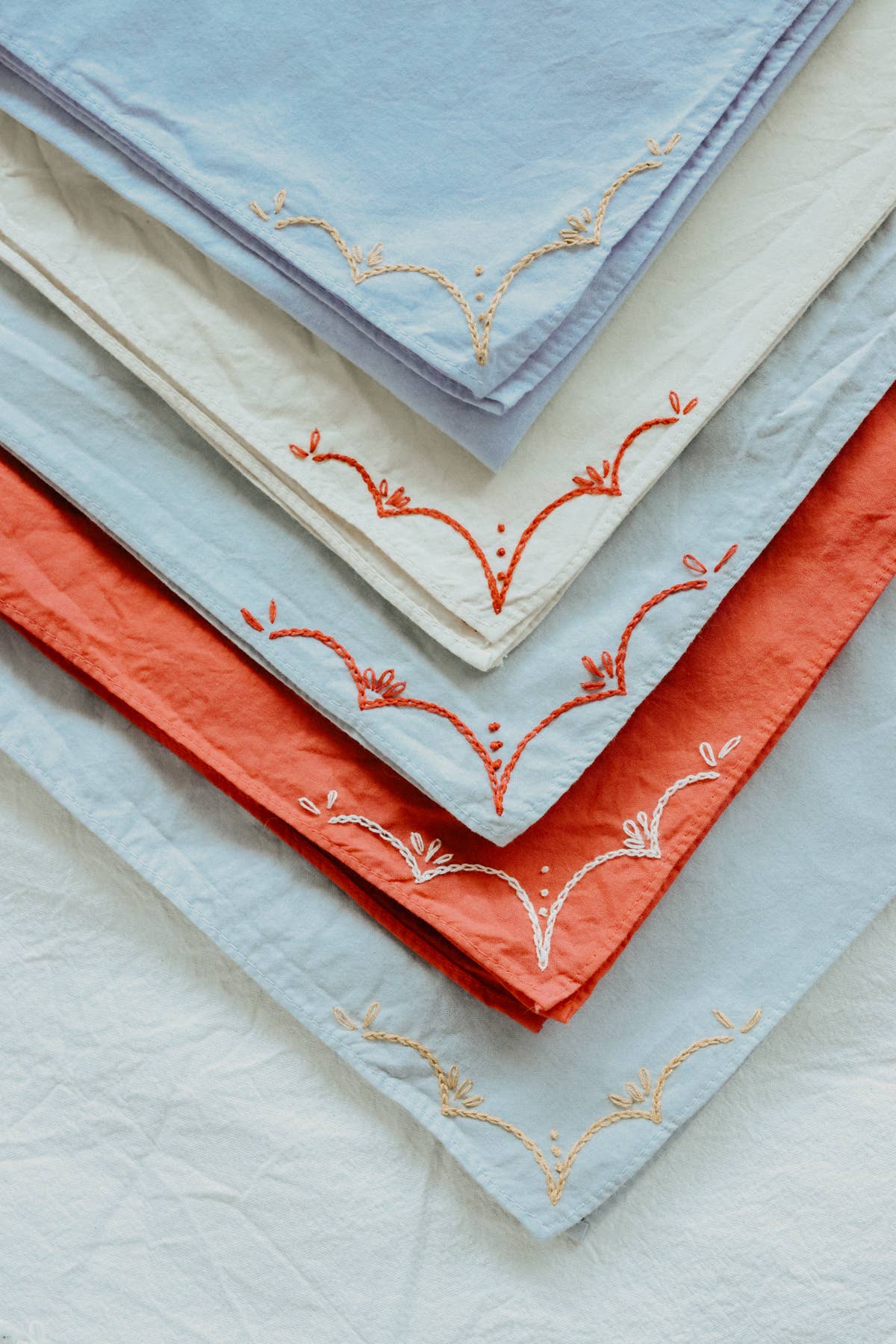 Hand-dyed embroidered rodeo cotton bandana in sandy white/red thread