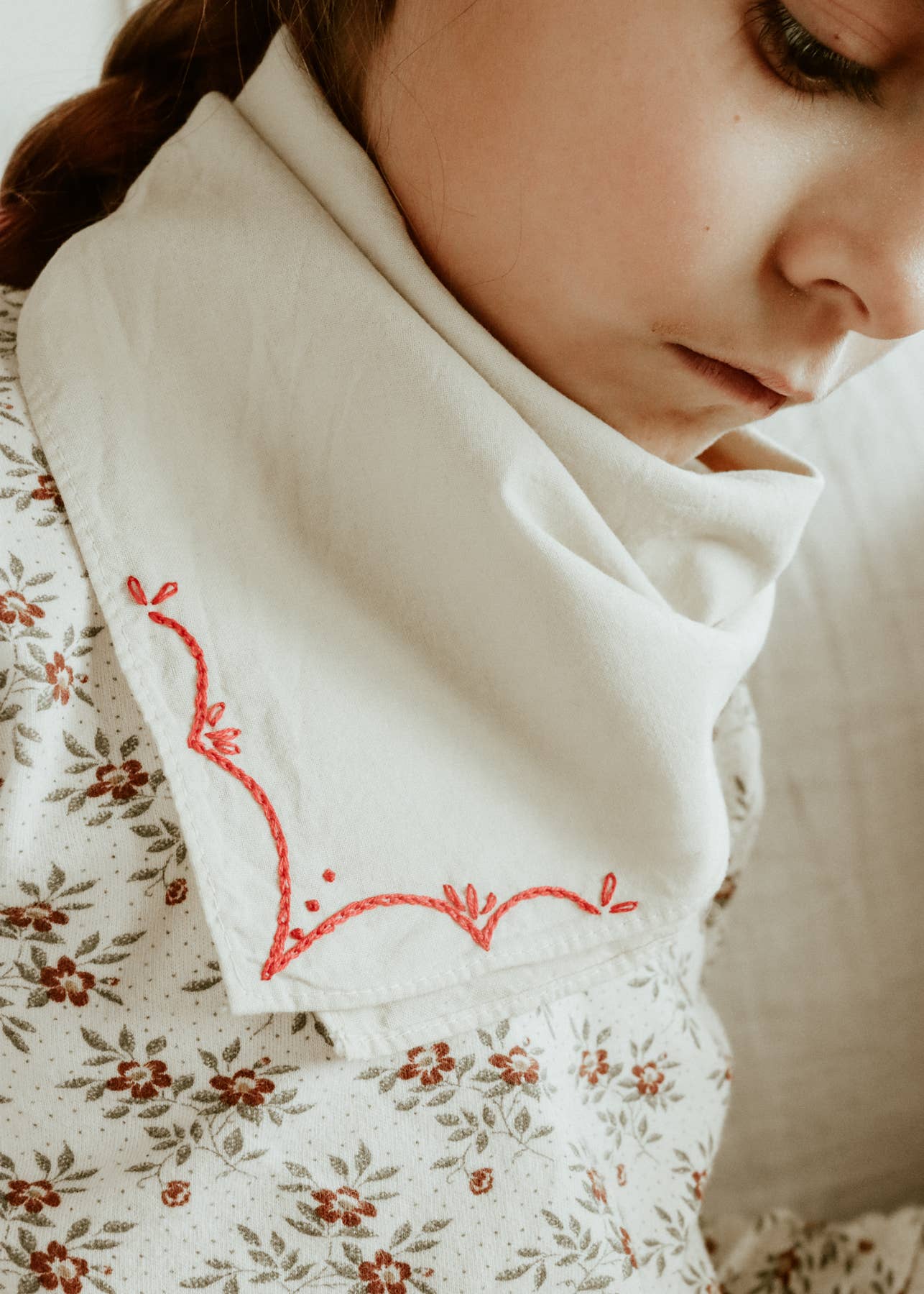 Hand-dyed embroidered rodeo cotton bandana in sandy white/red thread