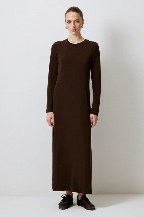 Woman wears a layered basic brown dress perfect for layering for a chic styled look from local Chicago boutique.